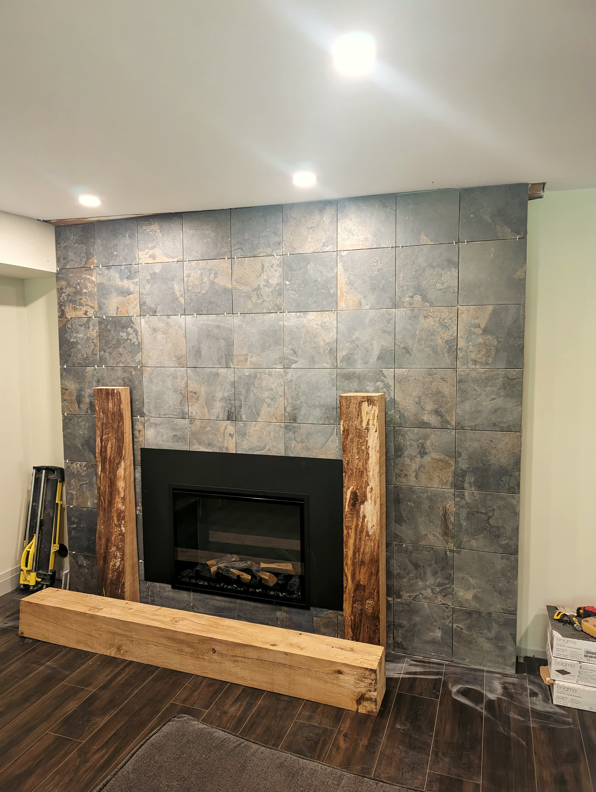Slate tile fireplace surround with live-edge timber legs and mantel